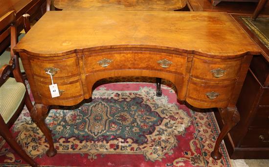 A walnut serpentine front dressing table, Width 107cm